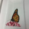 A butterfly sitting on top of pink flowers.