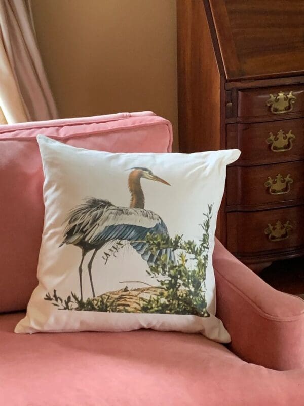 A close up of a pillow on the arm of a couch