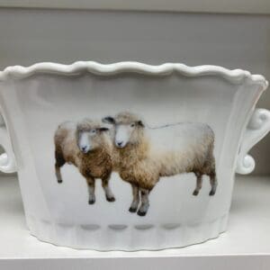 A bowl with two sheep on it